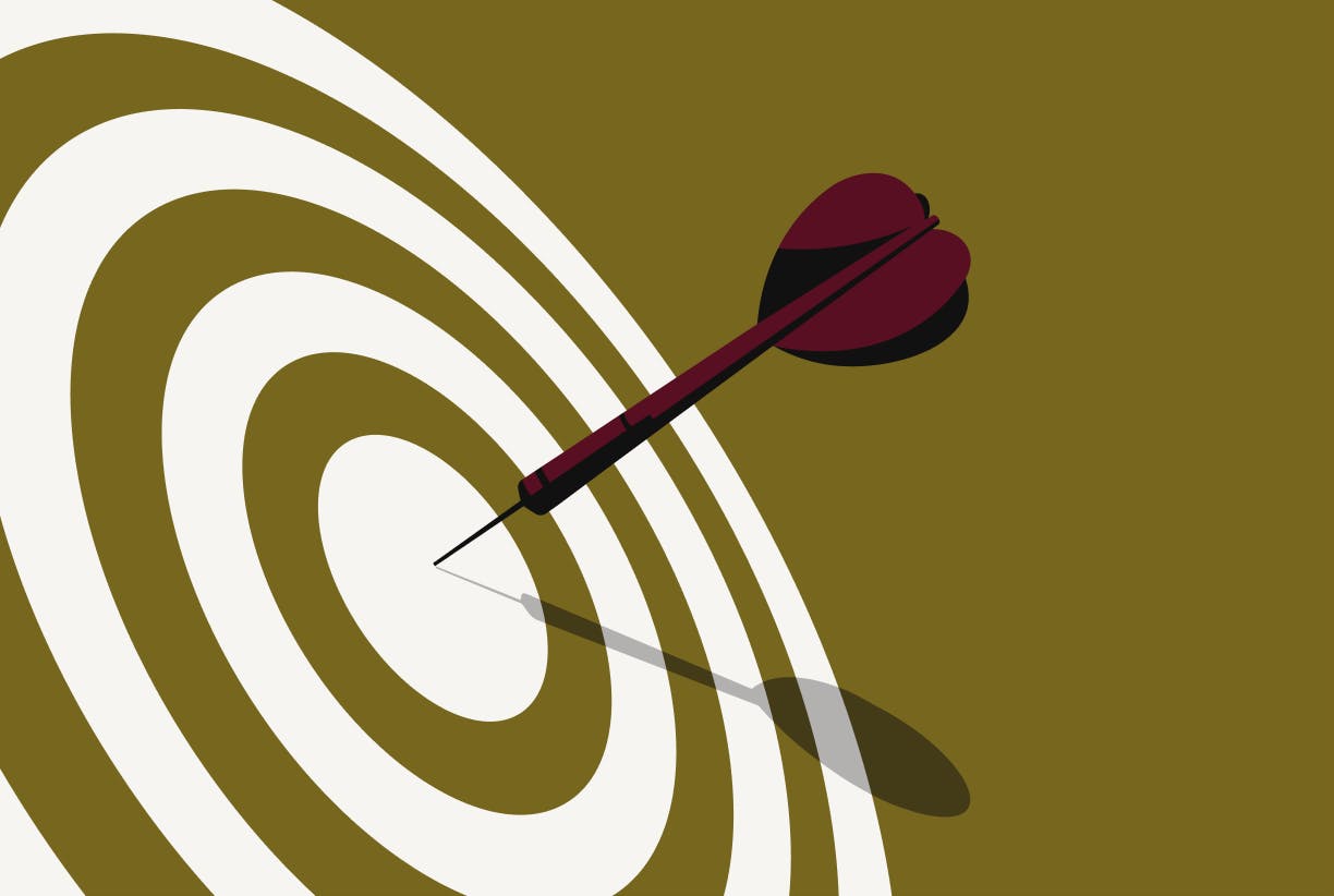 A dart hitting the center of a bull's eye on a green background. 