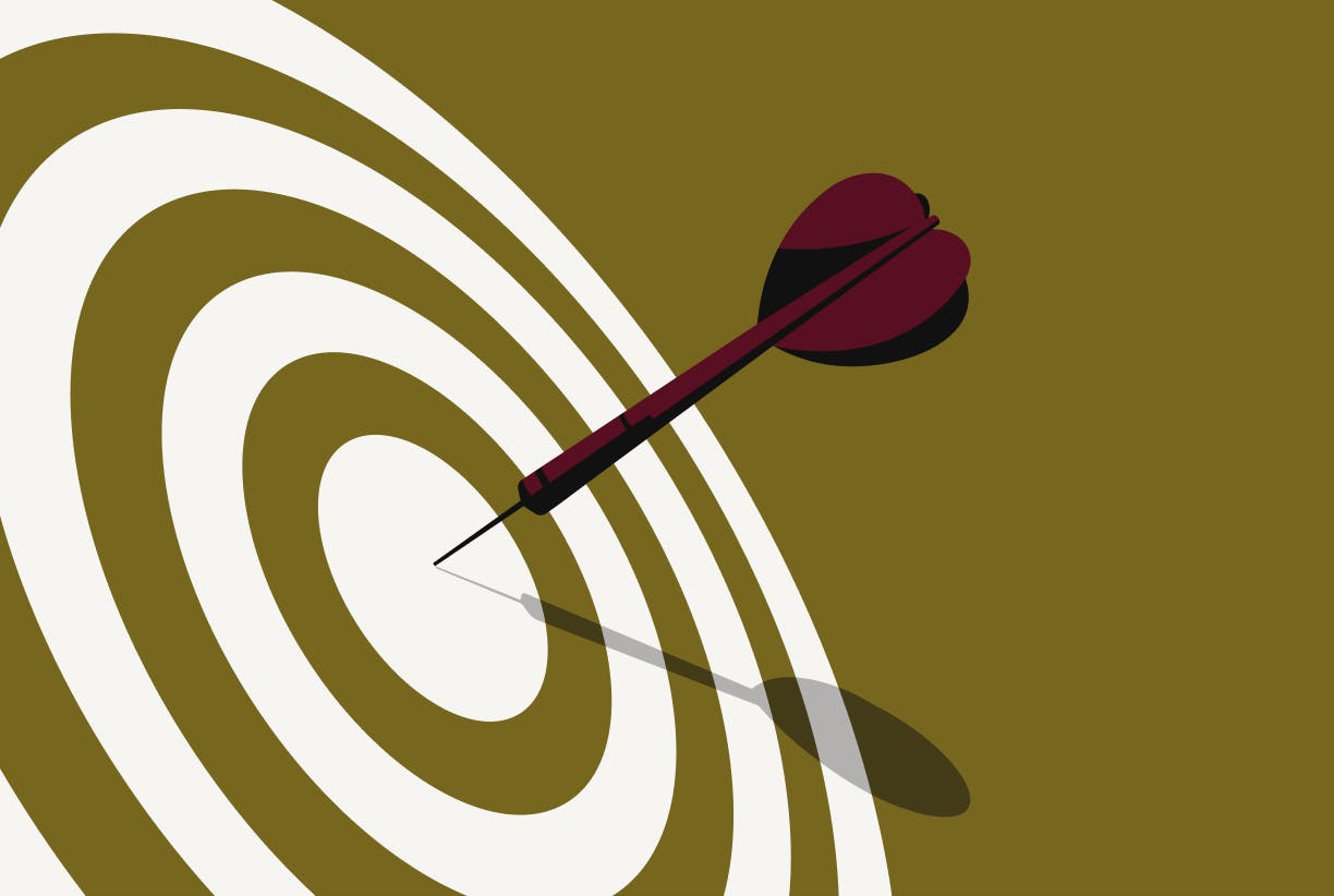 A dart hitting the center of a bull's eye on a green background.