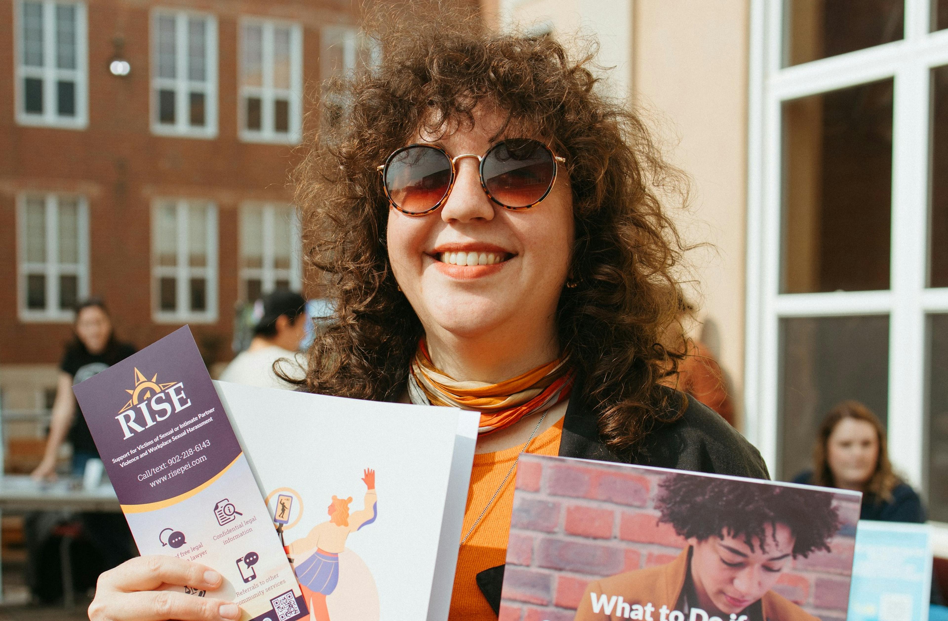 RISE program legal navigator Emma poses for a photo at the Holland College resource fair