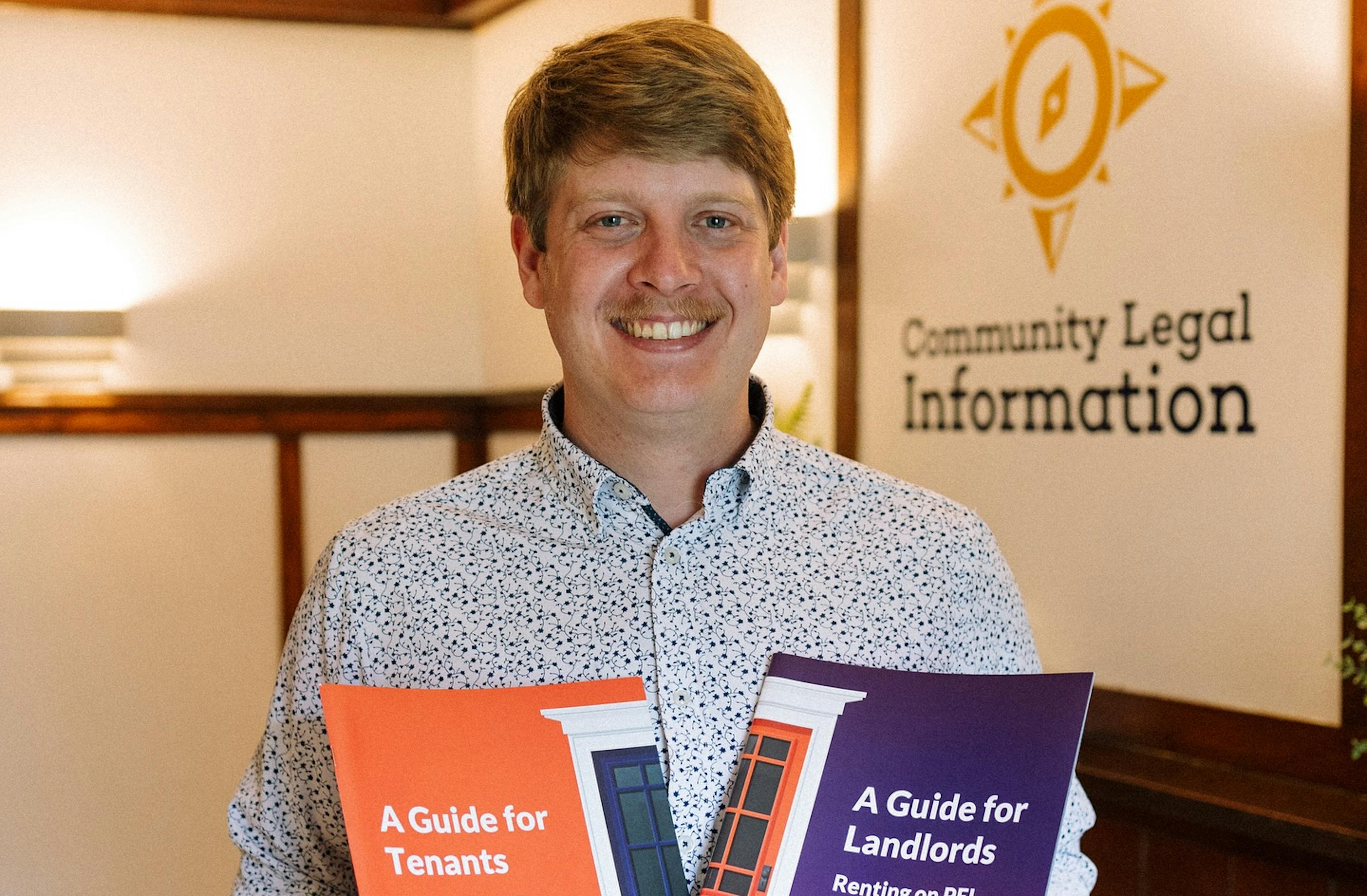 The Renting PEI program manager, Rowen, holds two publications - the guide for tenants and the guide for landlords