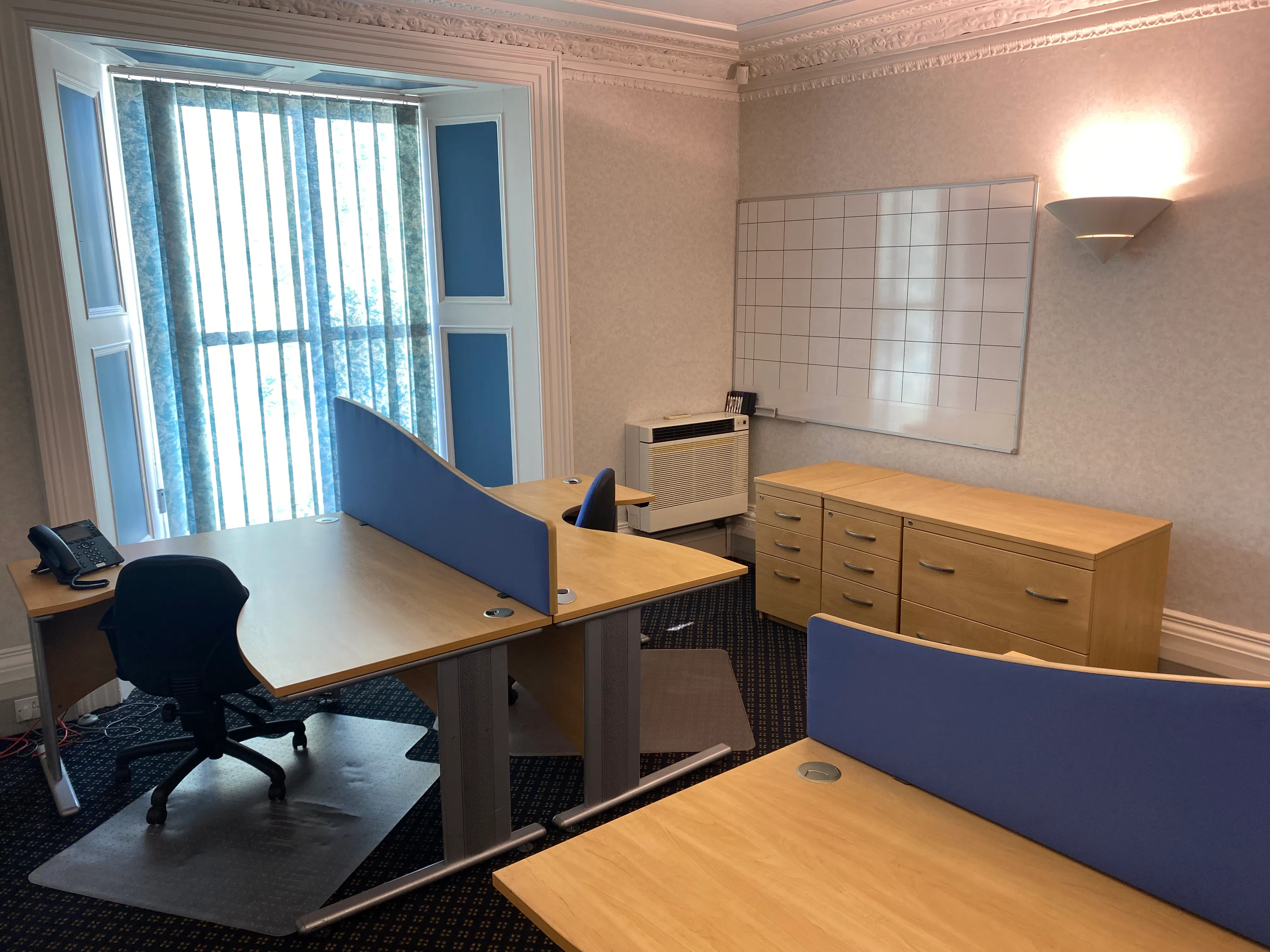 3 desk office with additional furniture