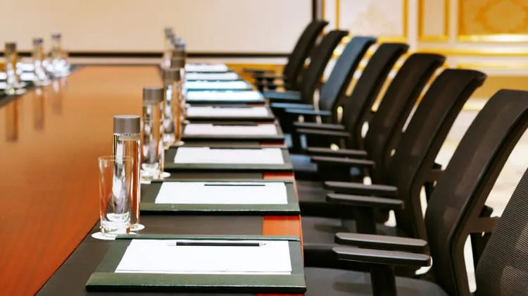 boardroom image with pads and chairs