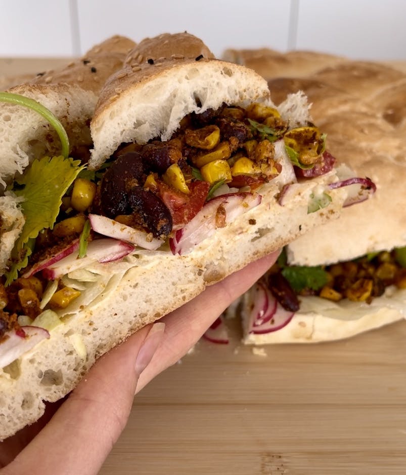 Turkish bread filled with hummus, kidney beans, corn, radishes and cilantro