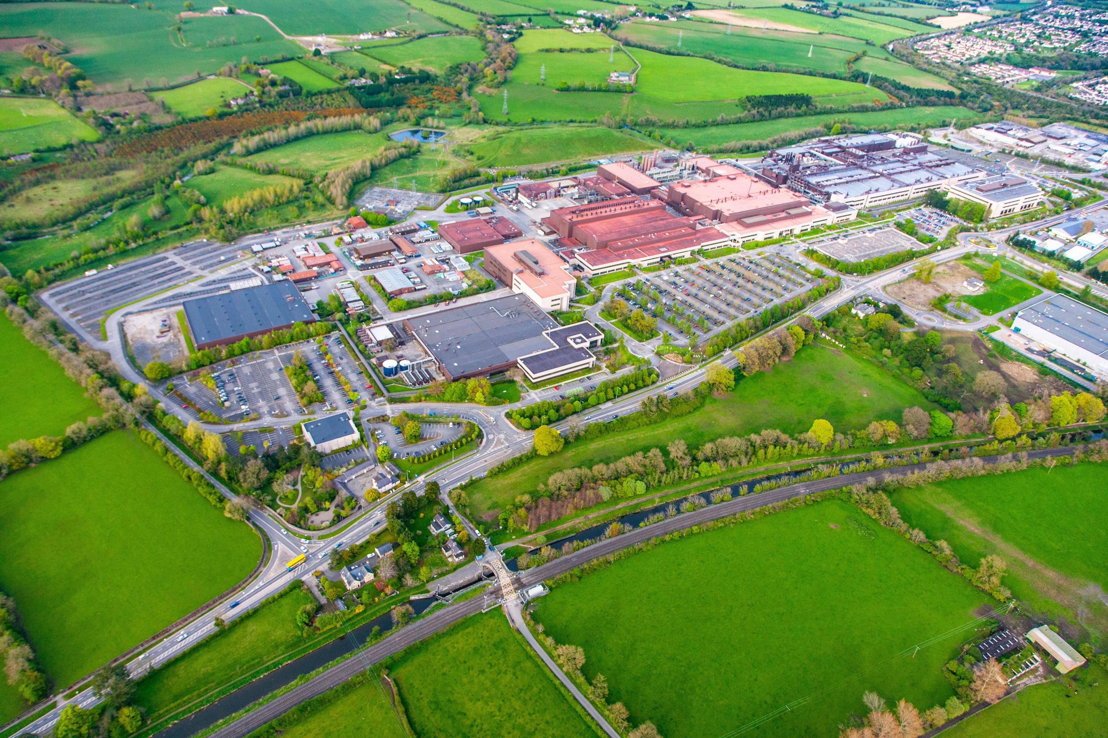 An arial view of a generic manufacturing facility, surrounded by countryside and housing developments