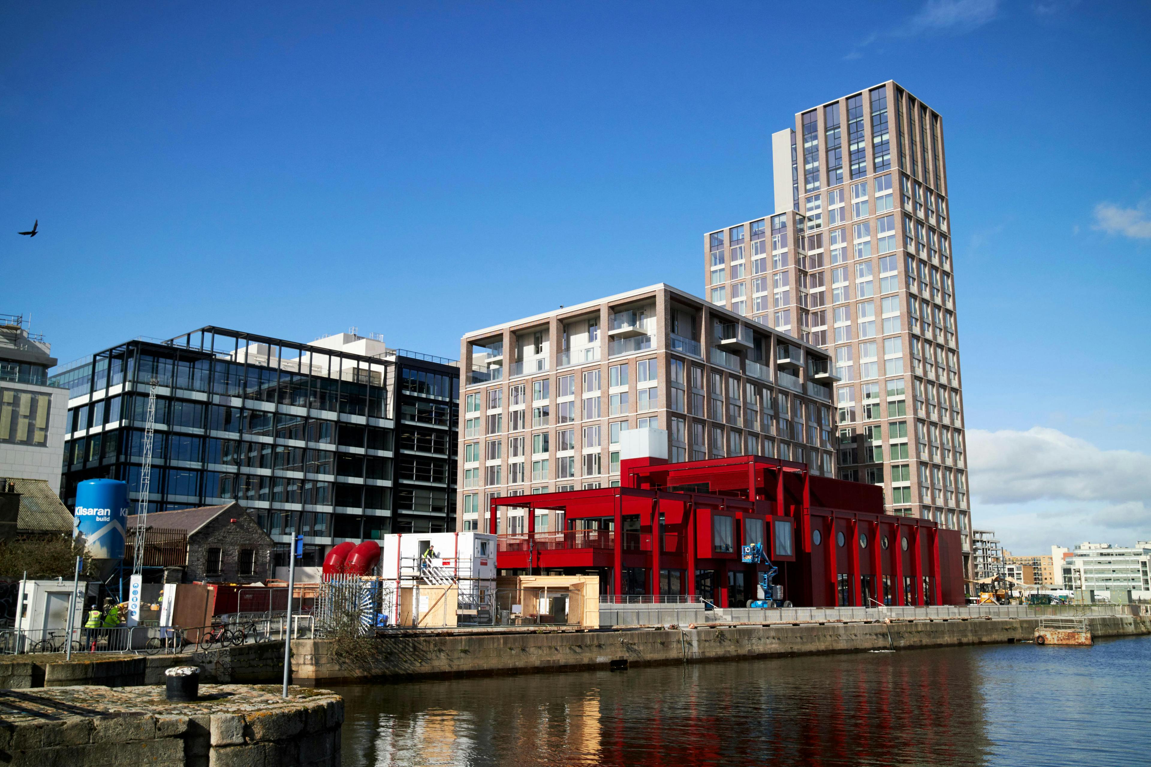 The Capital Dock development and surrounding buildings. The sun is shining.