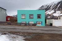 A photograph of a green house in Flateyri, Iceland.