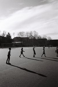 Kids playing football. Long shadows.