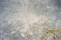 Concrete surface with a yellow rope.