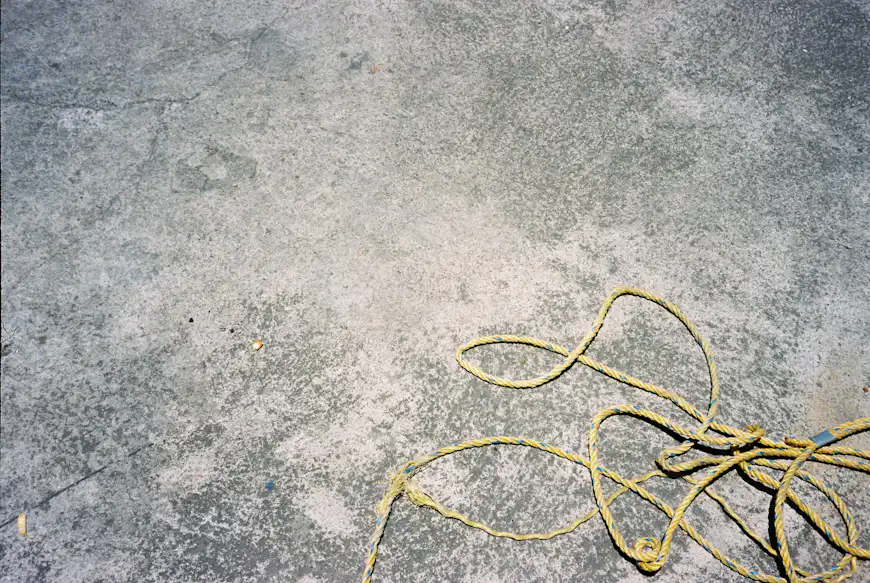 Concrete surface with a yellow rope.