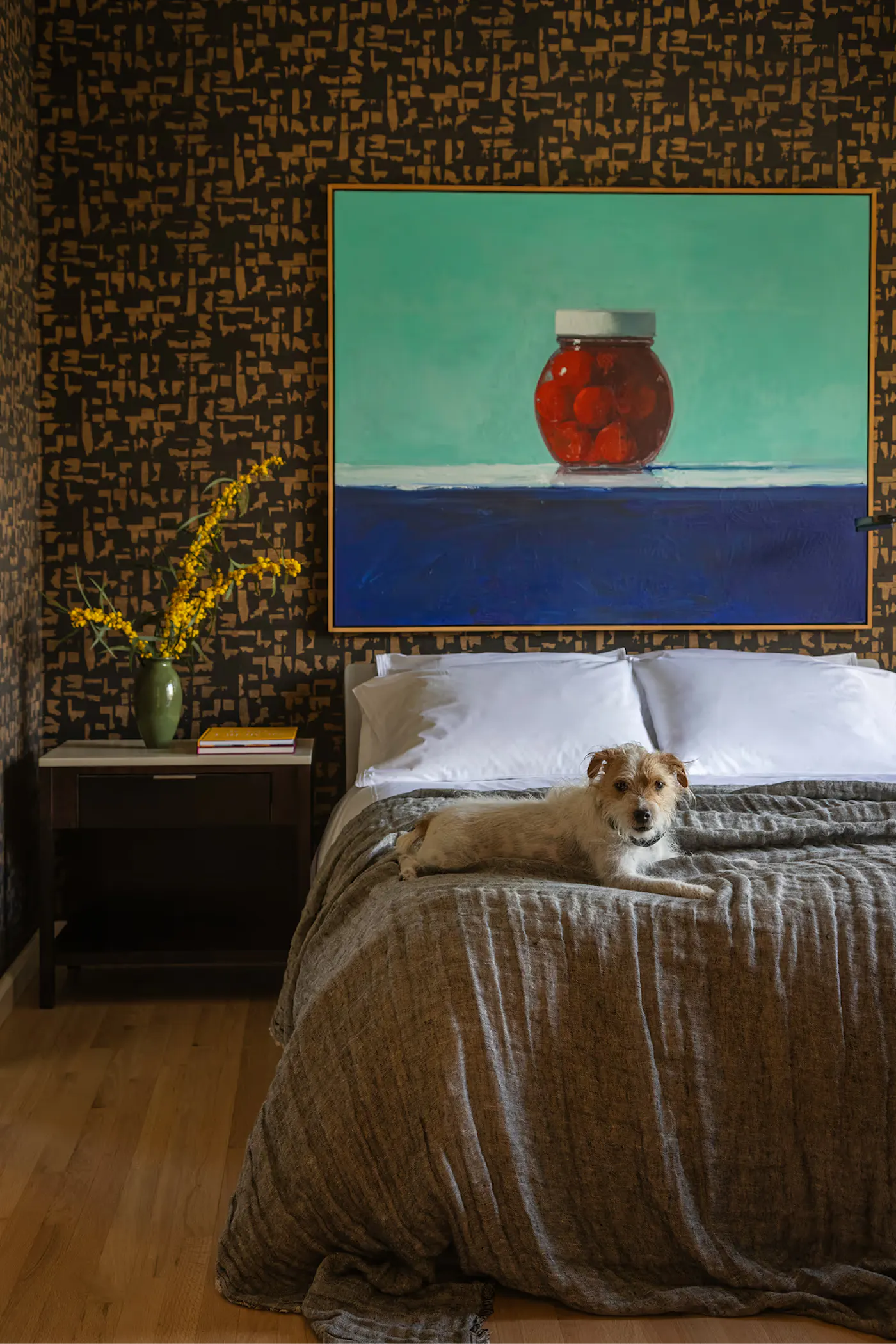 Salt Lake City interior design bedroom with bold wallpaper, statement painting, and relaxed styling with dog on bed