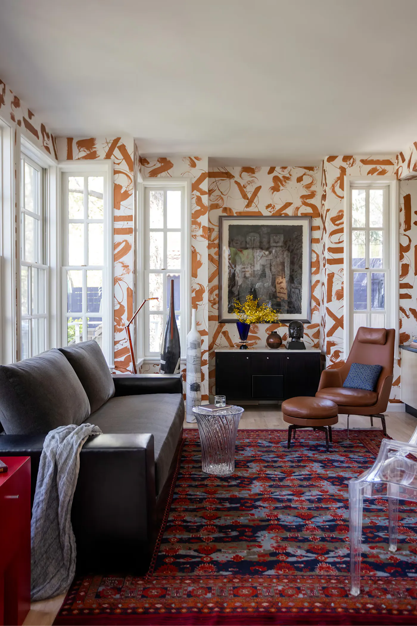 Salt Lake City interior design living room with mural walls, leather seating, and curated art and decor