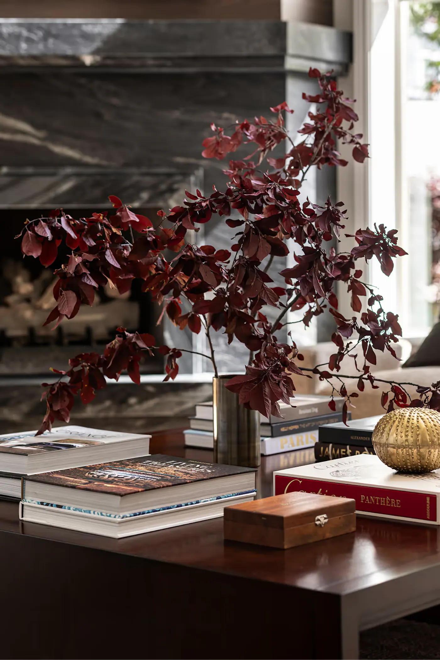 Luxury living room styling with curated decor, books, and floral arrangement