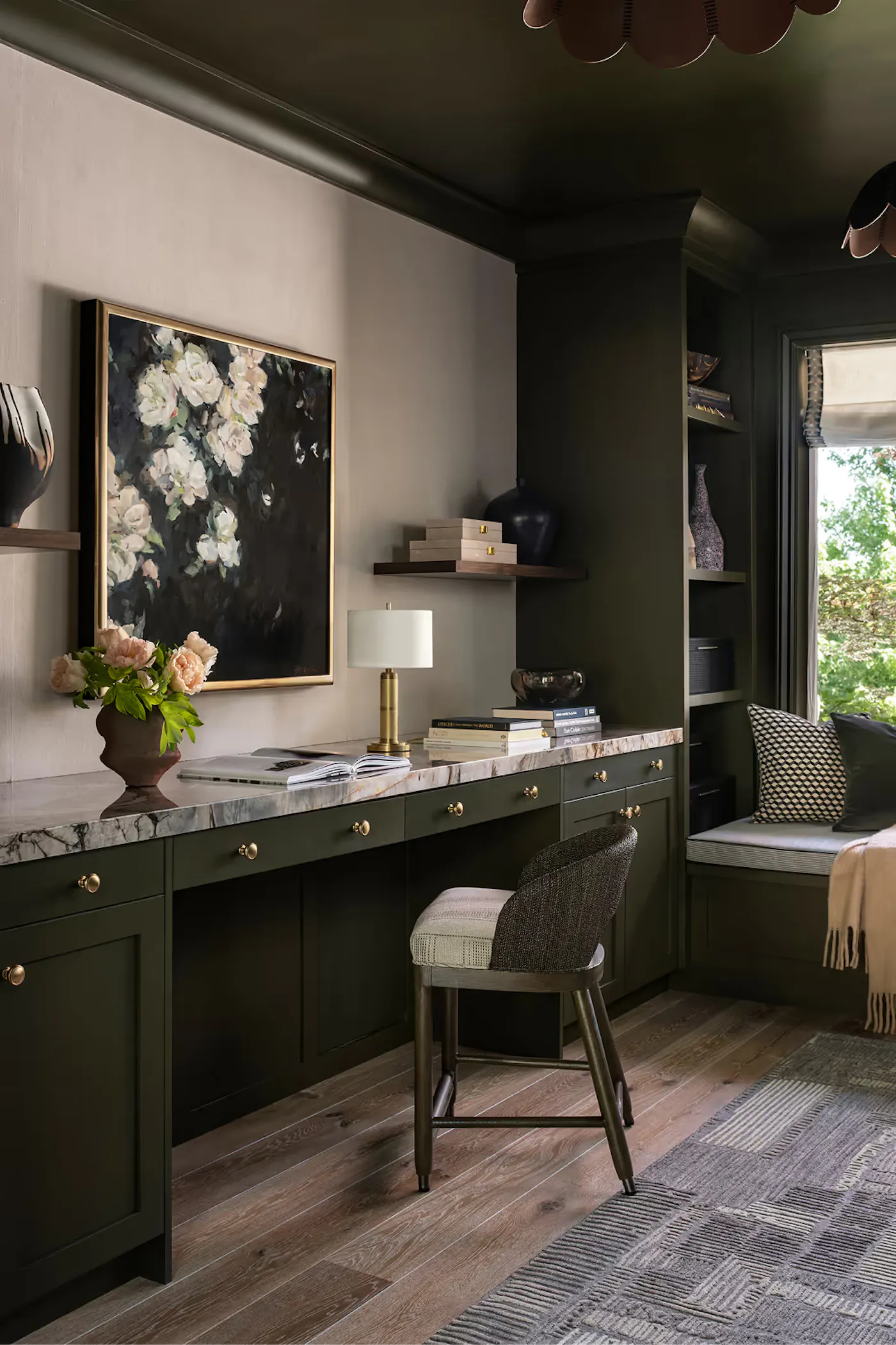 Custom home office with built-in cabinetry, marble countertop, and moody green finishes
