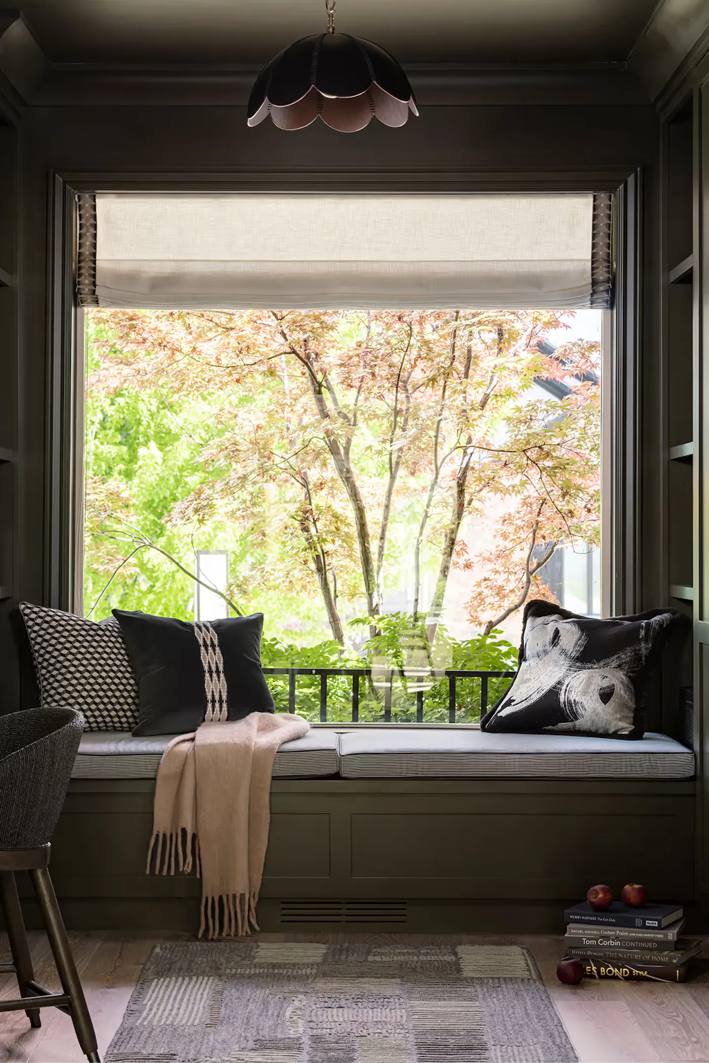 Cozy window seat with custom millwork and garden views
