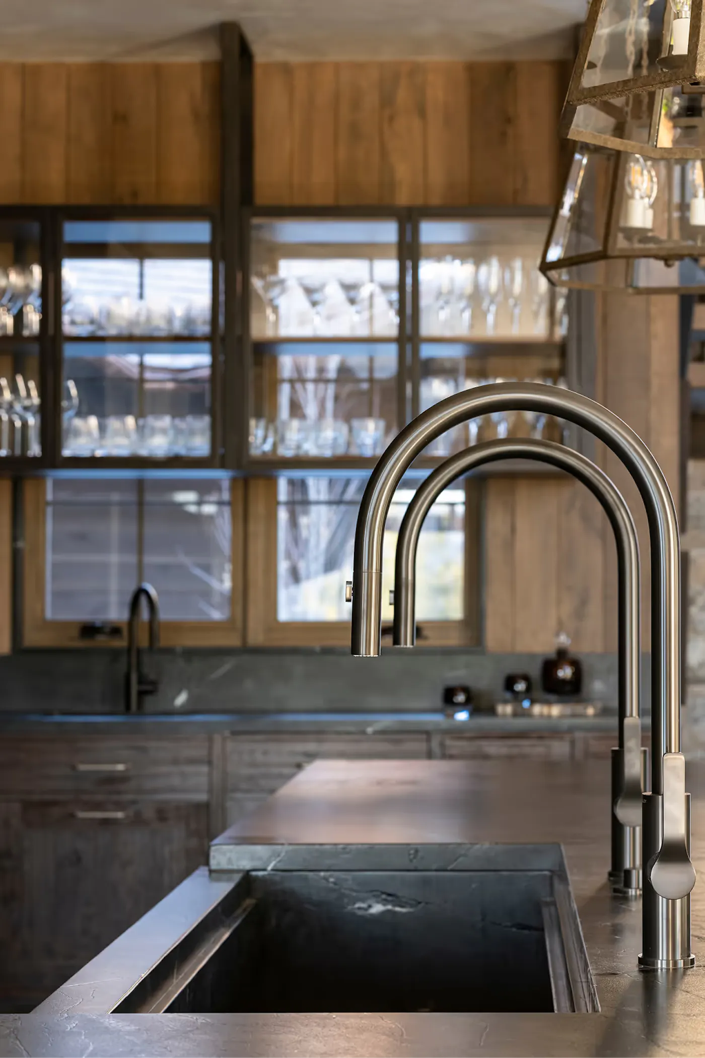 High-end kitchen sink with custom stone and brushed metal fixtures