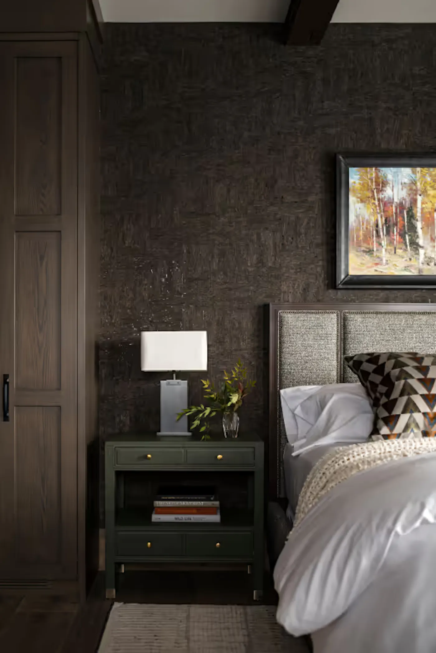 Bedroom detail with textured wall finish and nightstand