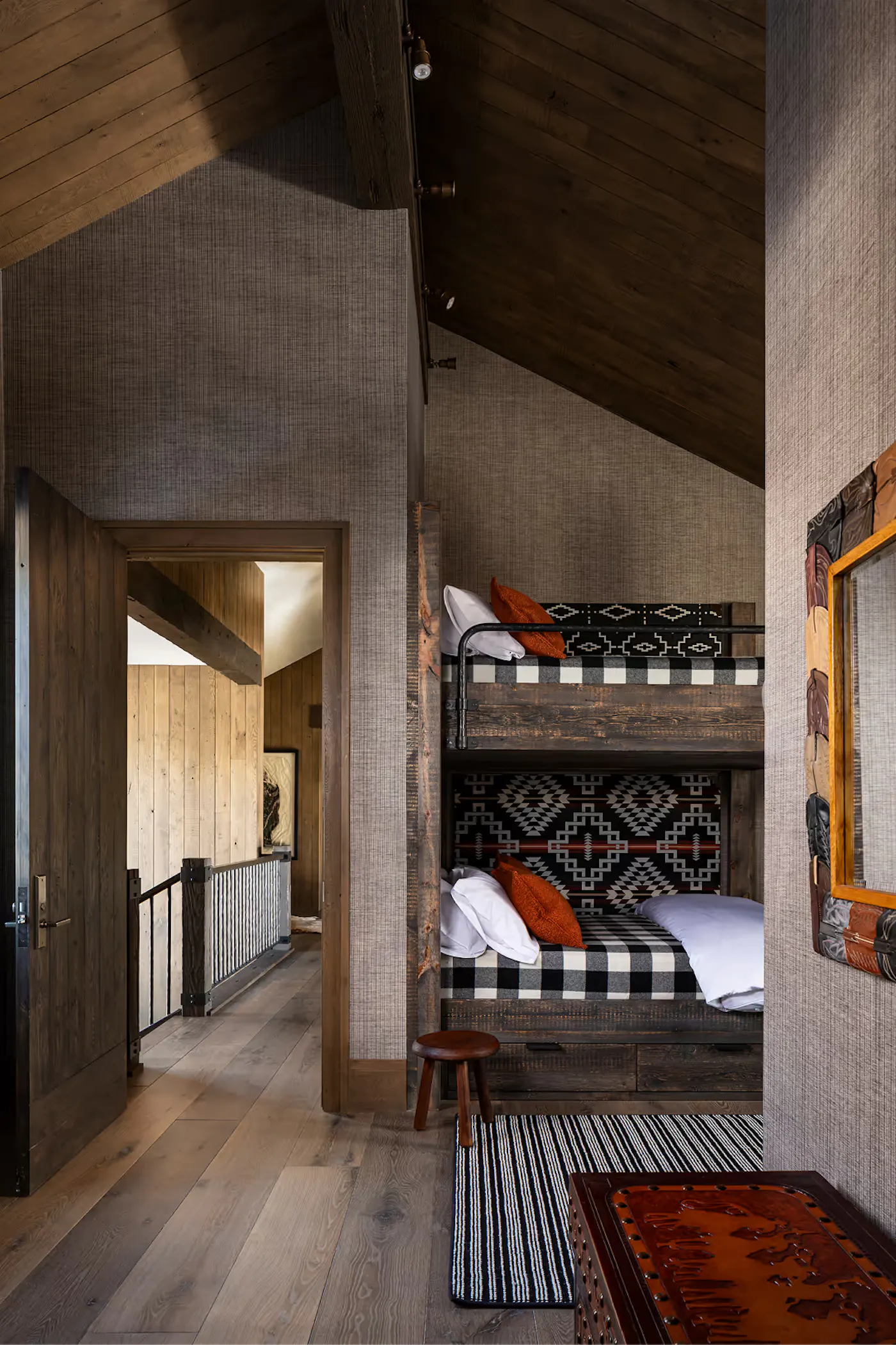 Mountain home bunk room with built-in beds and connected circulation space