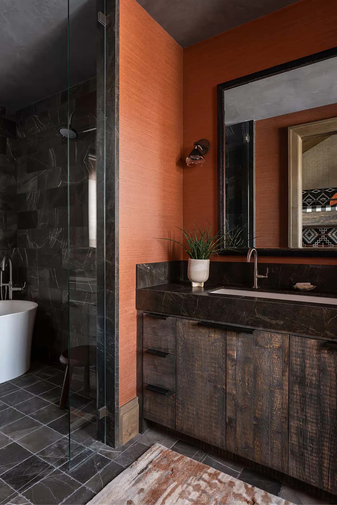 Rustic bathroom with wood vanity, stone countertop, and glass shower enclosure