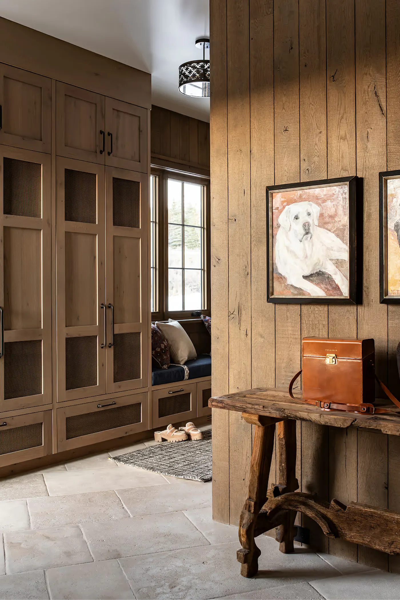 Park City mountain home mudroom with built-in cabinets and window bench
