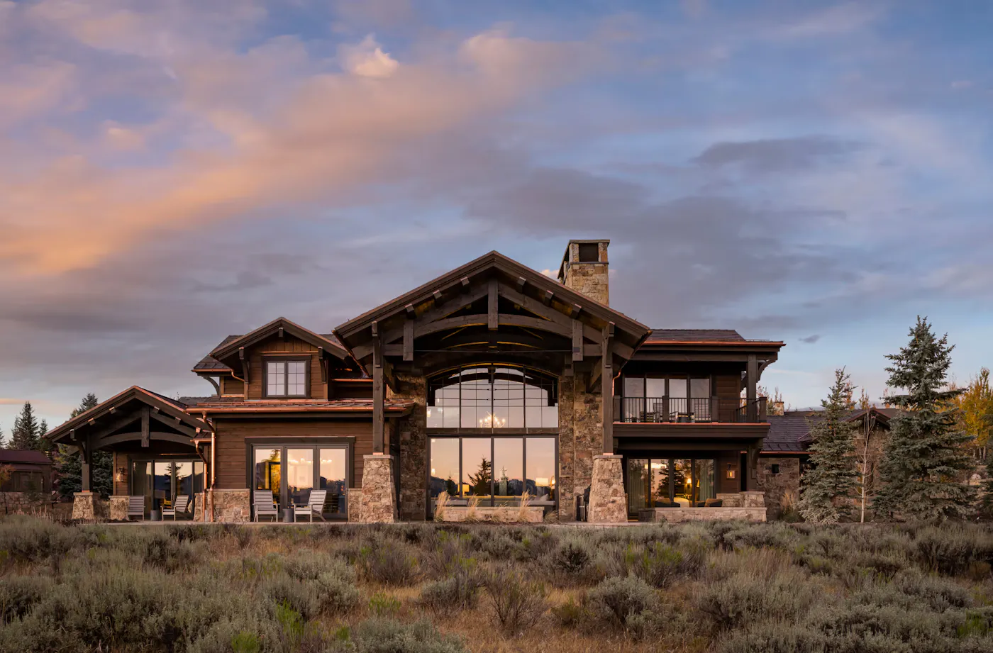Modern rustic Park City mountain home with exposed timber structure and stone exterior