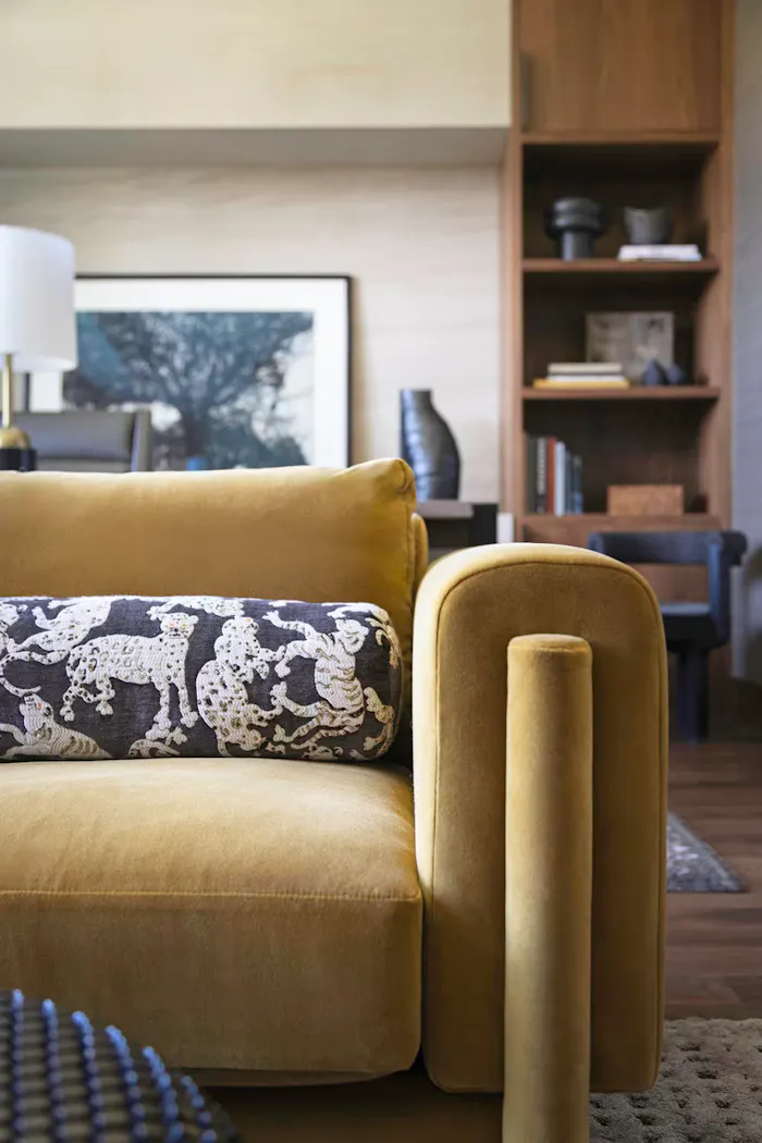 Leslie Schofield Studio living room design with rich velvet seating, curated decorative accents, and warm wood tones