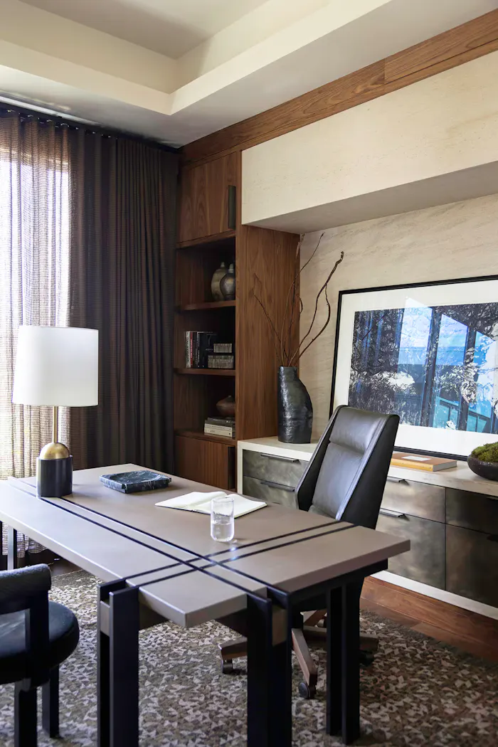 Sophisticated contemporary home office with custom walnut millwork, modern executive desk, and layered natural textures by Leslie Schofield Studio