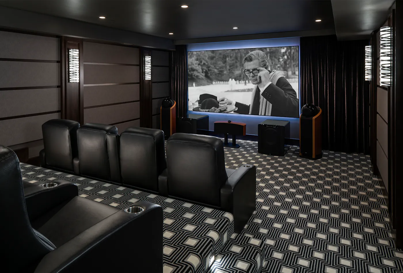Home Theatre room with two rows of black theatre style chairs, black and white 