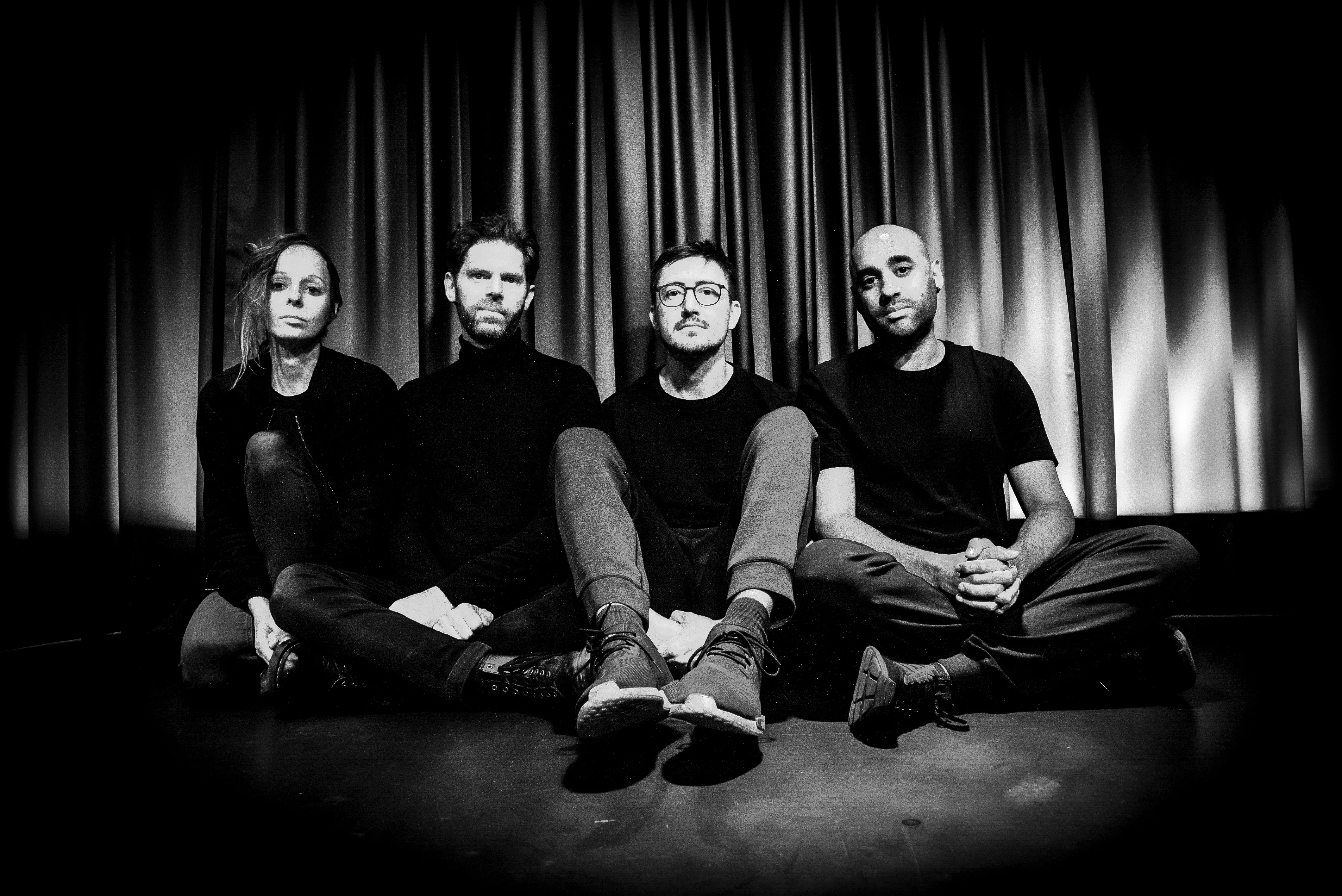 let spin sitting down looking at the camera in black and white