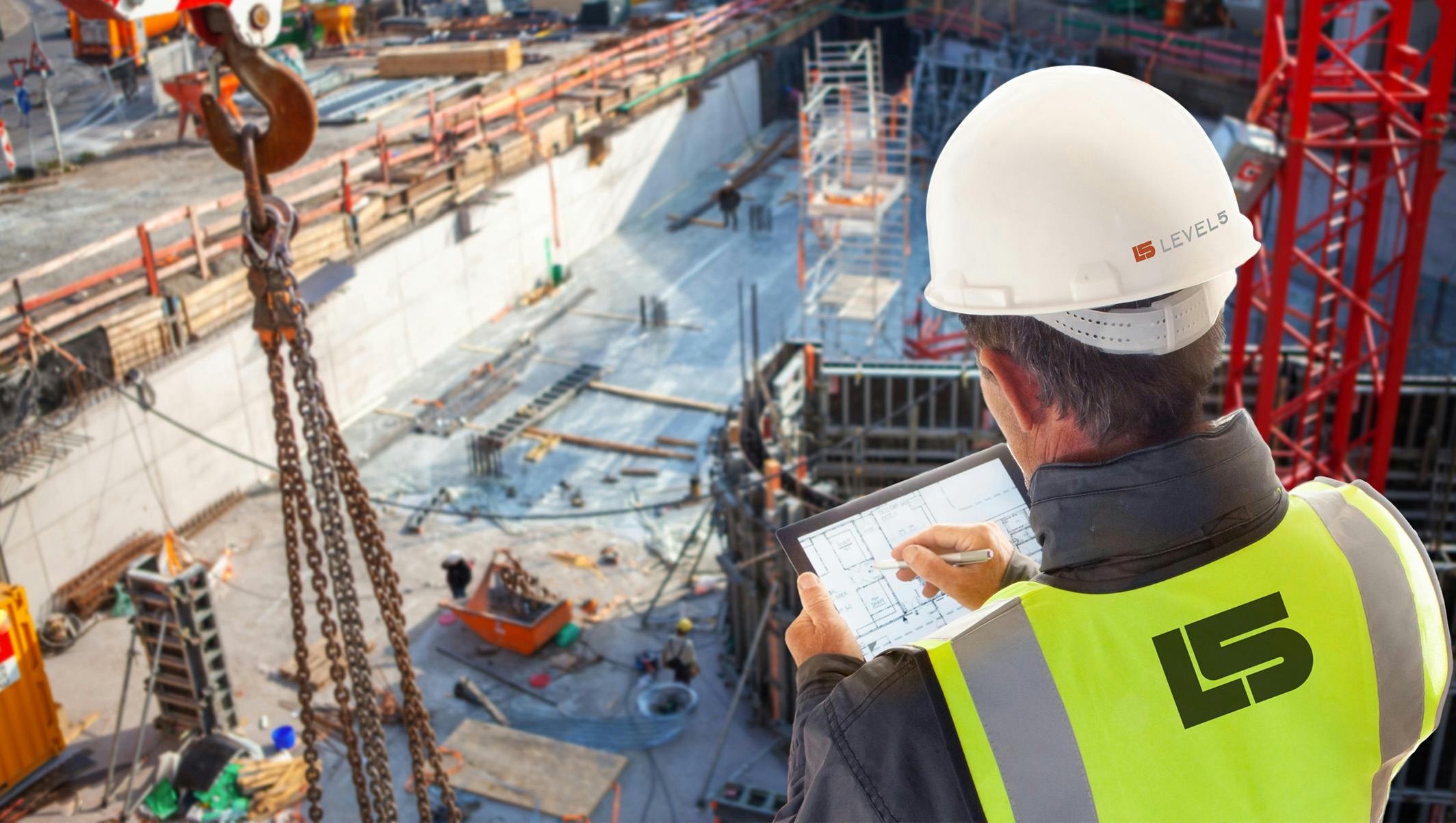 A construction worker looking over his plans at a site