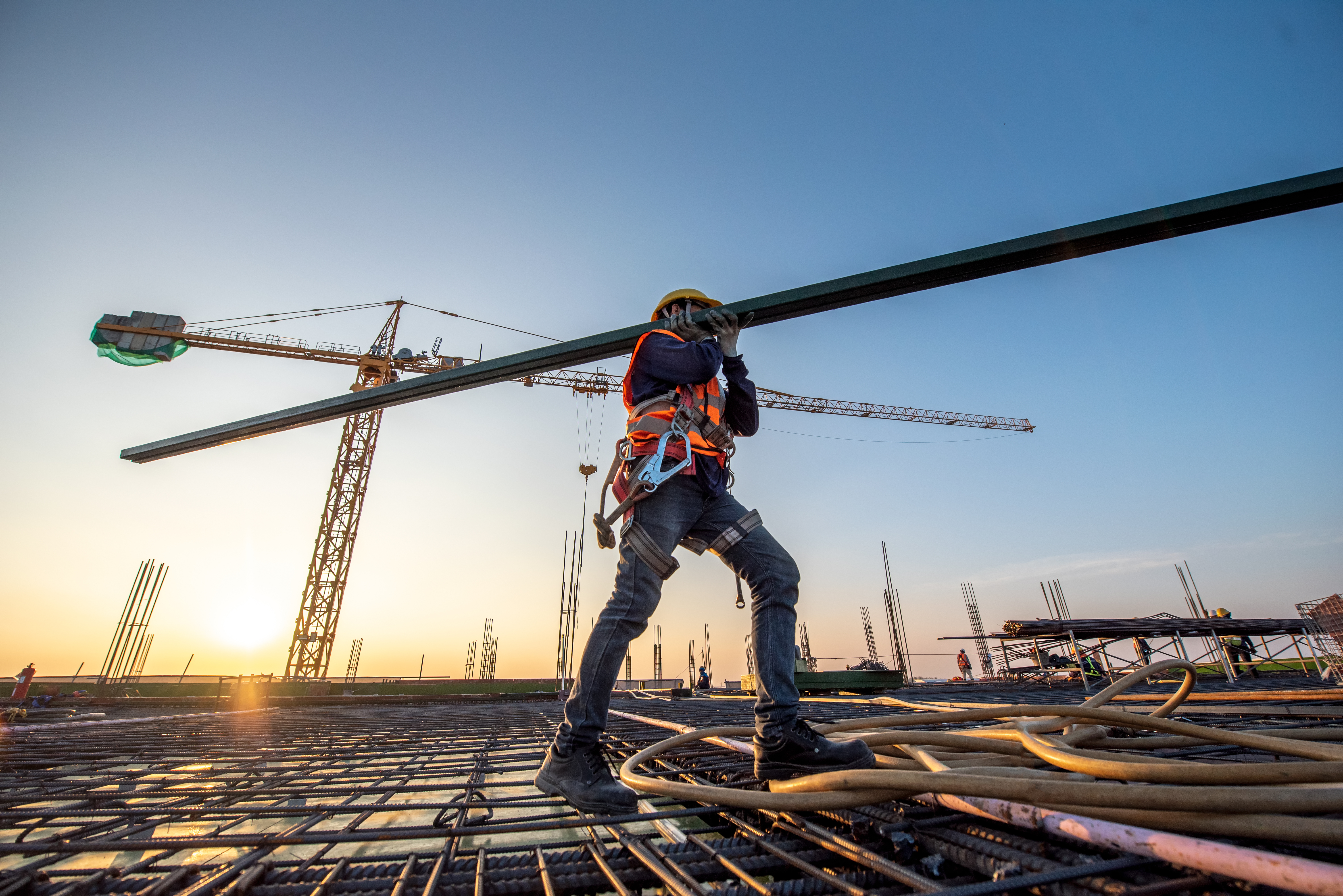 Photo of construction worker carrying supplies on aconstruction site