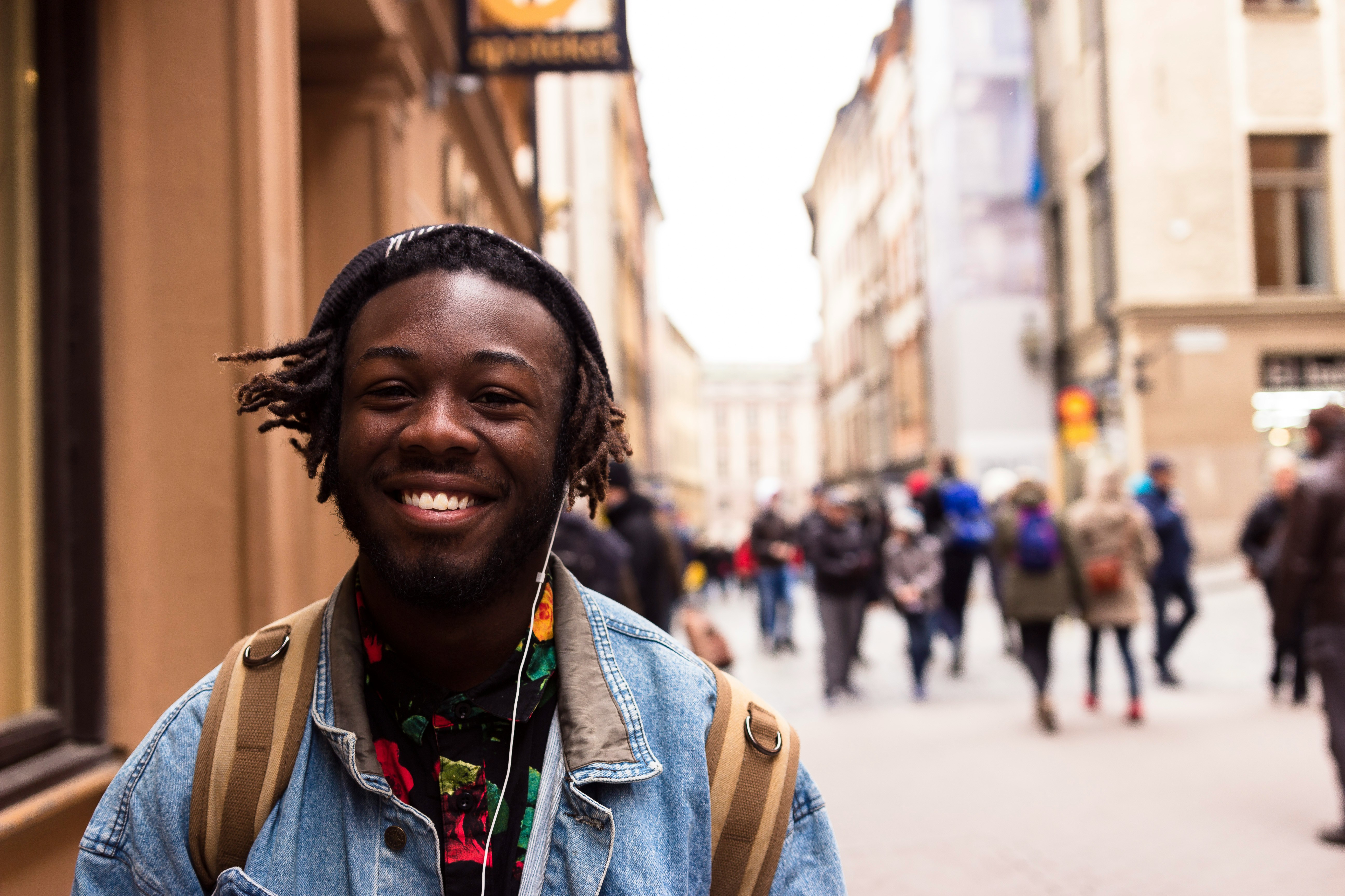 A smiling man walking towards you in the city