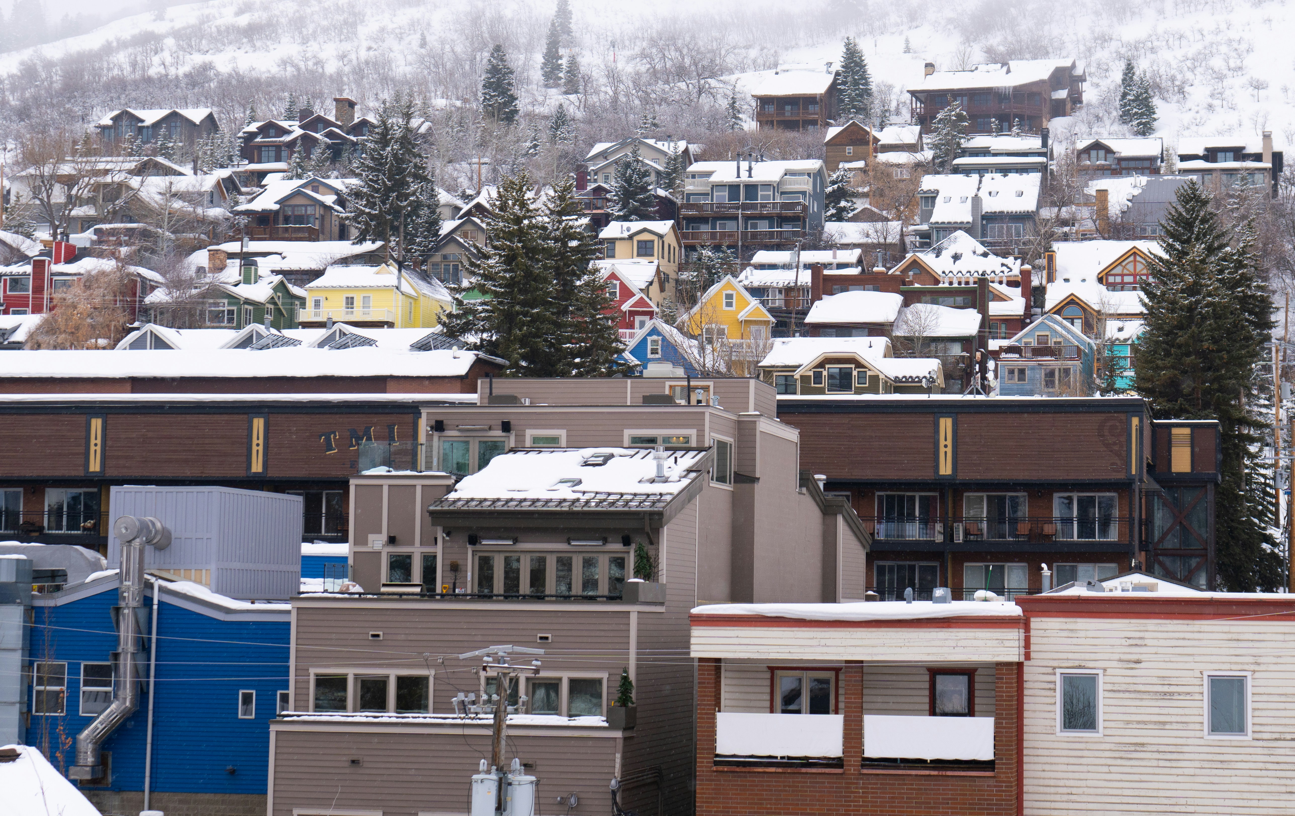 Photo of small town buildings in the winter with snow on the roofs