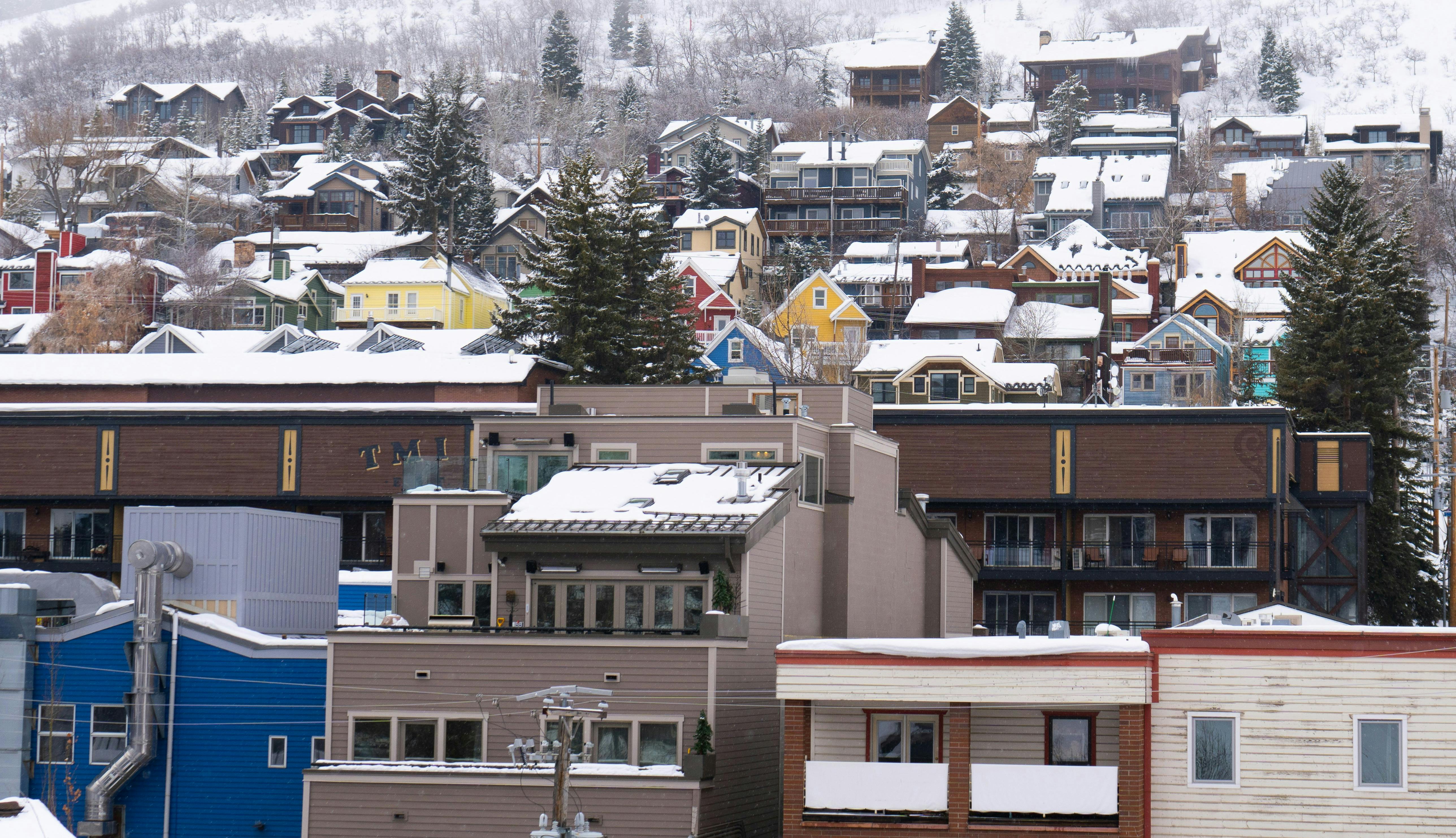 Photo of small town buildings in the winter with snow on the roofs