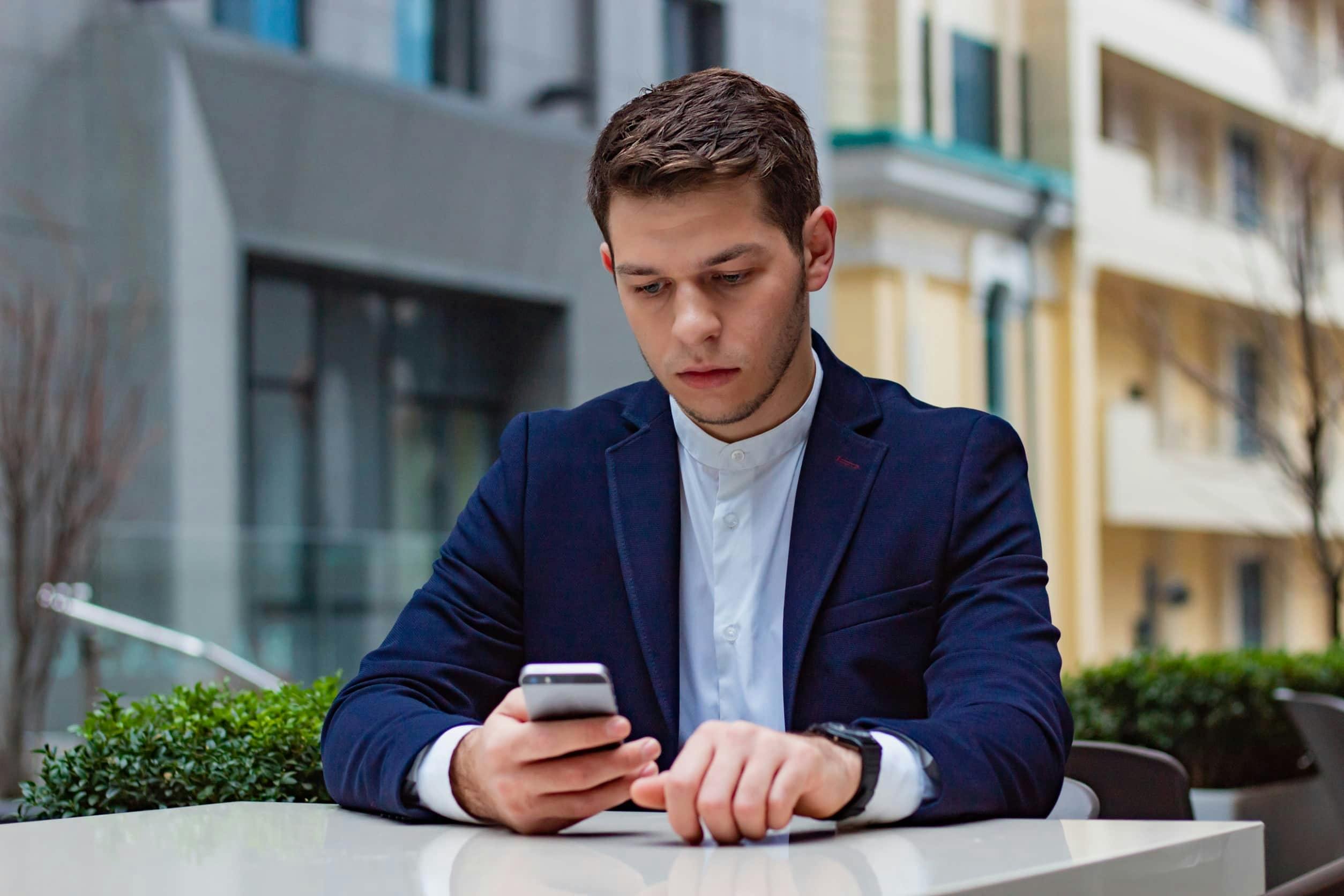 A Gen-Z man reading on his phone