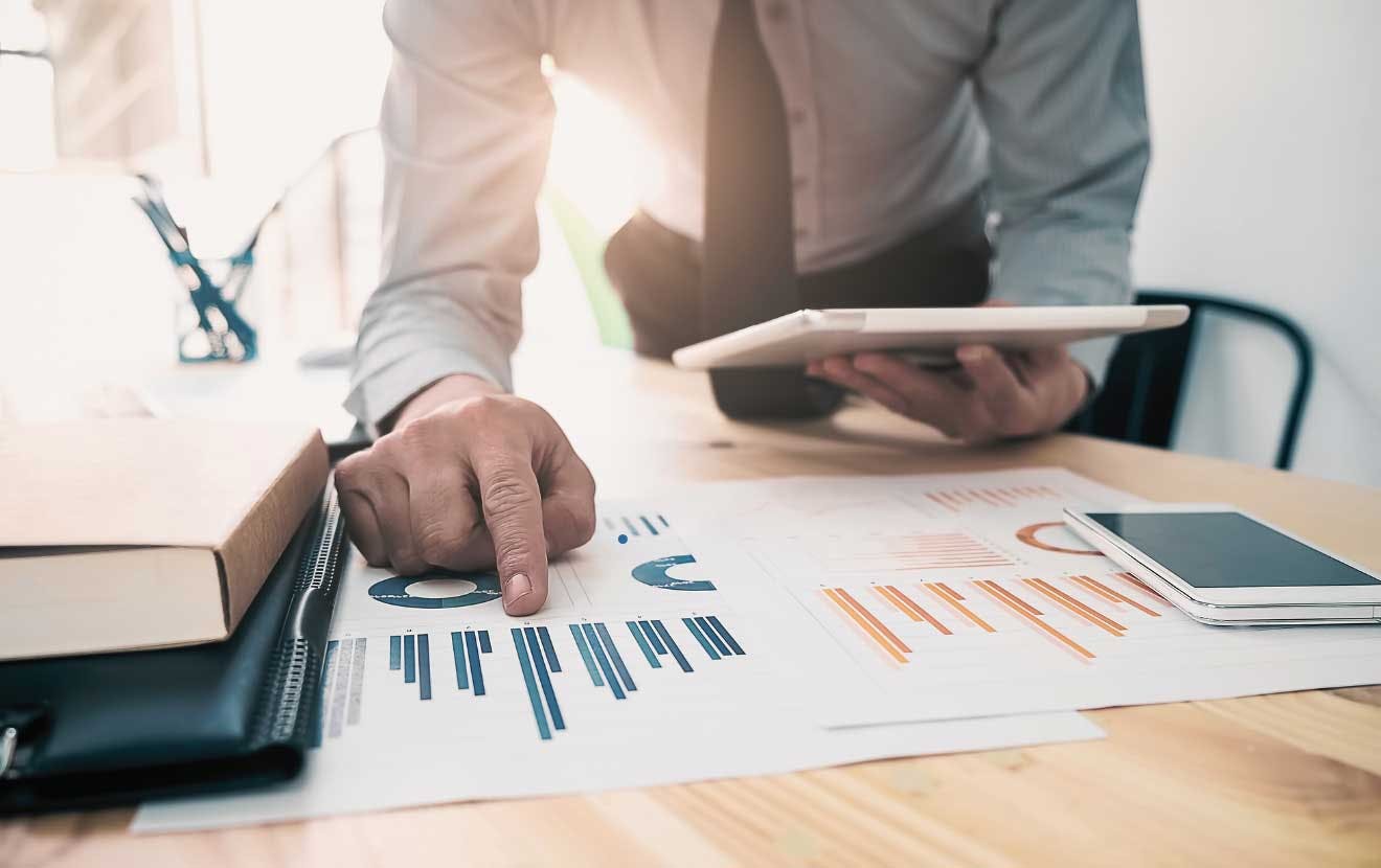 Man looking at charts on a piece of paper