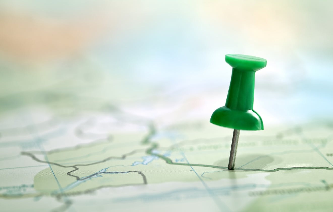 close up image of a push pin on a map
