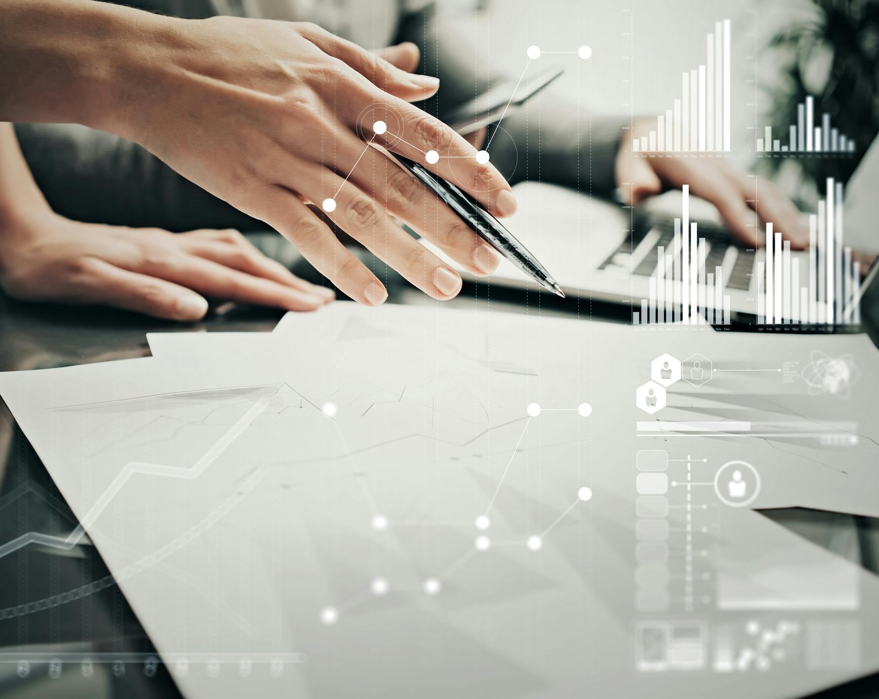 hand holding pen over papers, data icons