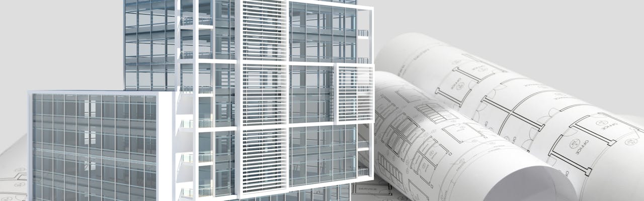 Building next to rolled up blueprints