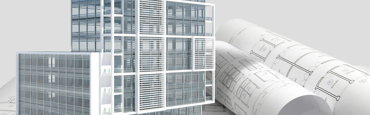 Building next to rolled up blueprints