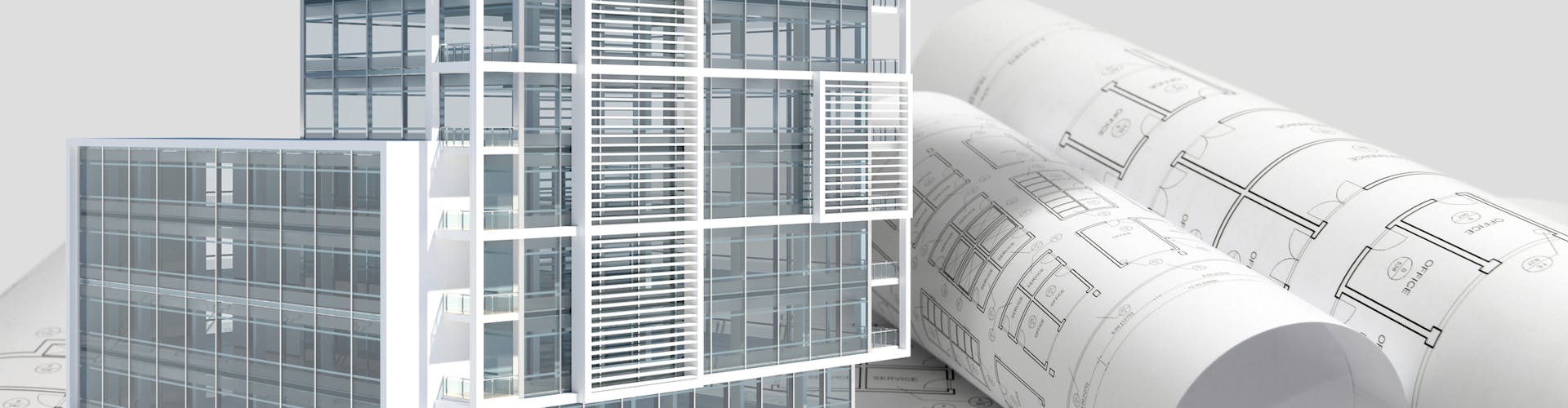 Building next to rolled up blueprints