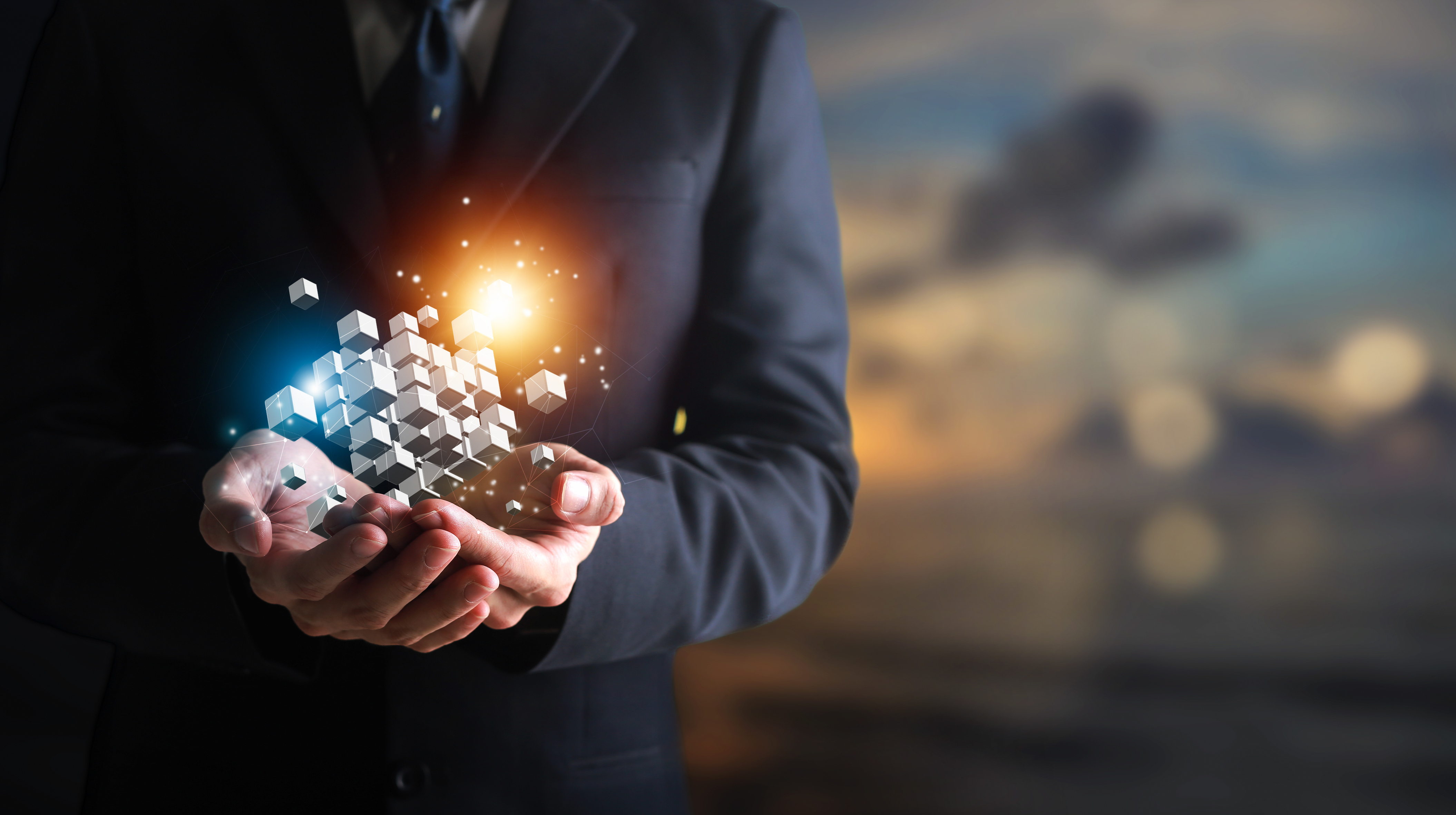 Hands holding building blocks floating outward