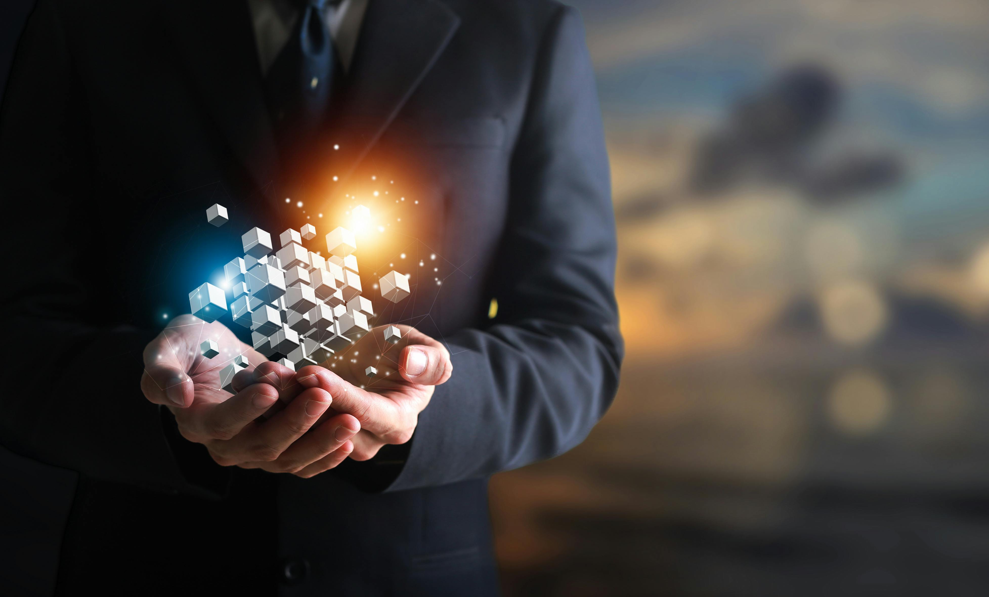 Hands holding building blocks floating outward