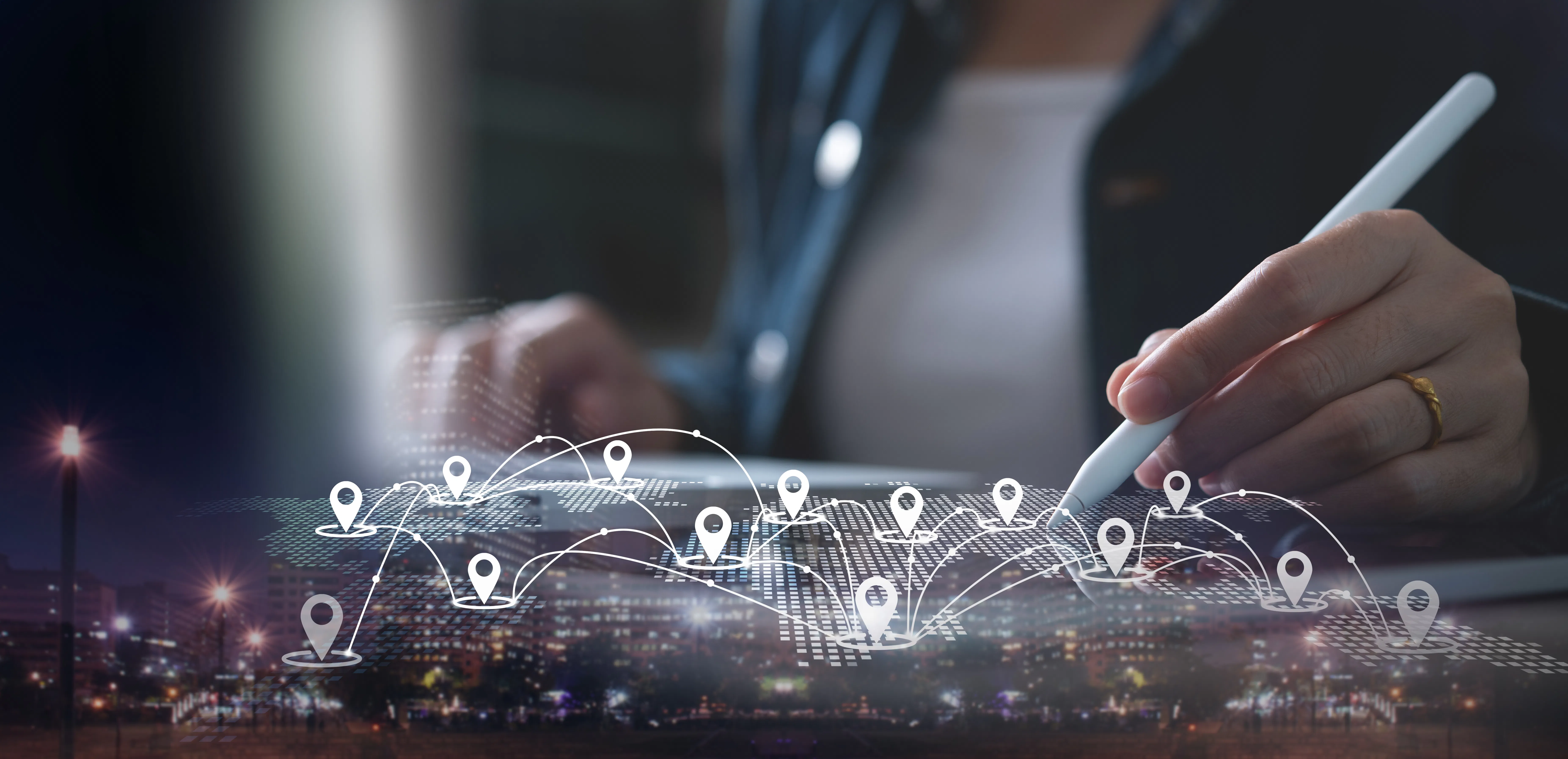 location icons on an ipad, hand holding pen