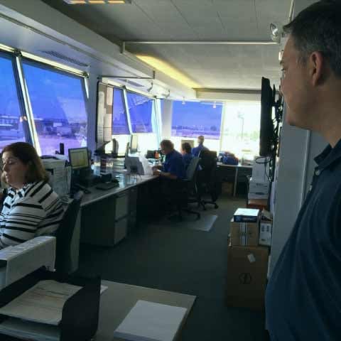 Railroad employees in a control tower supervising a train yard