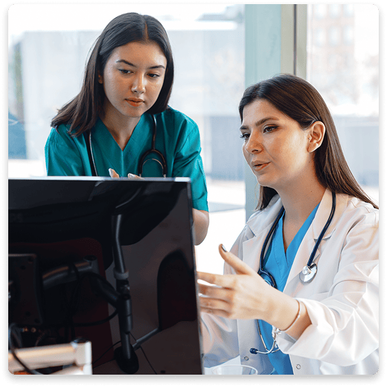 Medical personnel reviewing a monitor