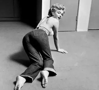 A vintage photo of woman on the floor wearing jeans