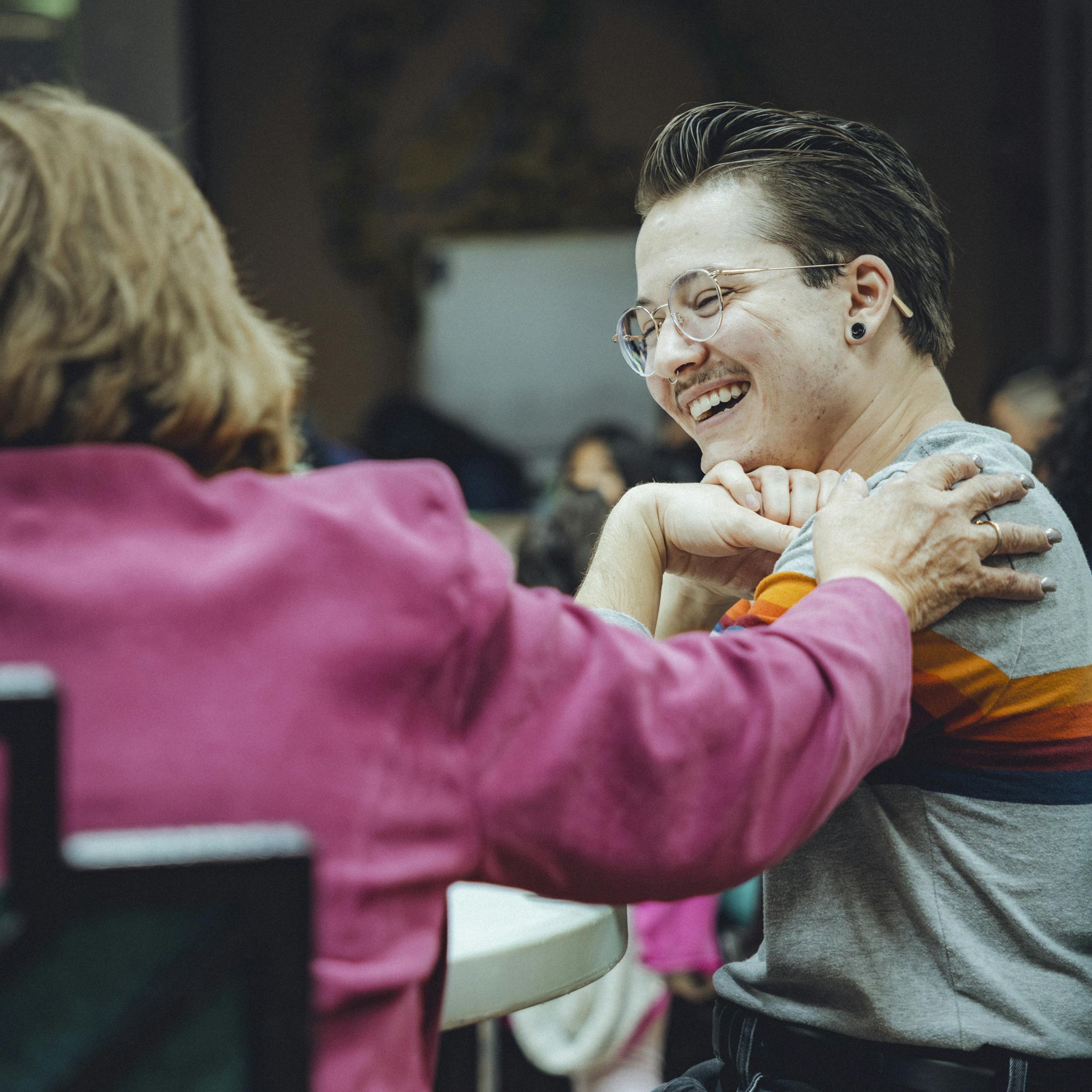 Woman put her hand on their shoulder to show encouragement.