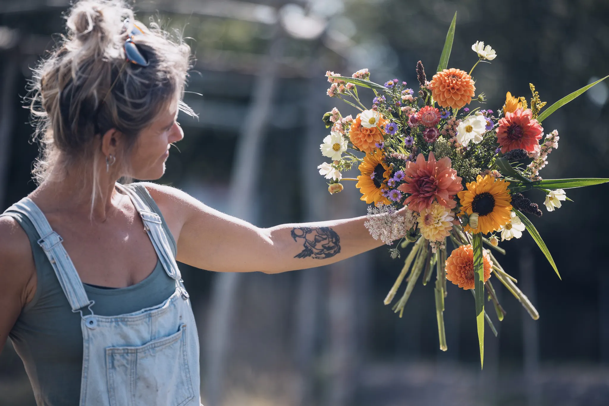 Foto van bio bloemenboerin Anais van Bloemenwij met een zomers bioboeket recht van het veld
