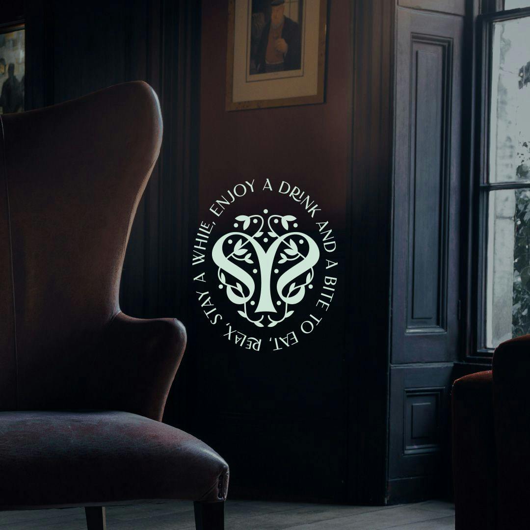 logo with text over moody chair