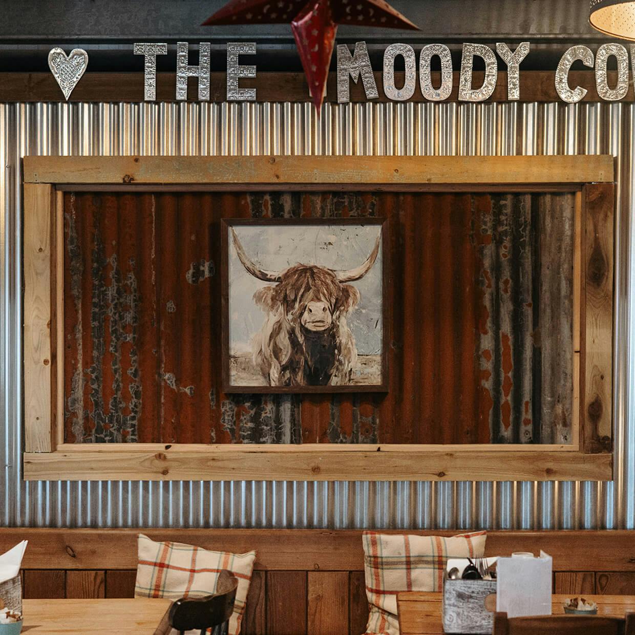 moody cow logo decor